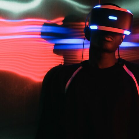 Man wearing virtual reality goggles with neon lights