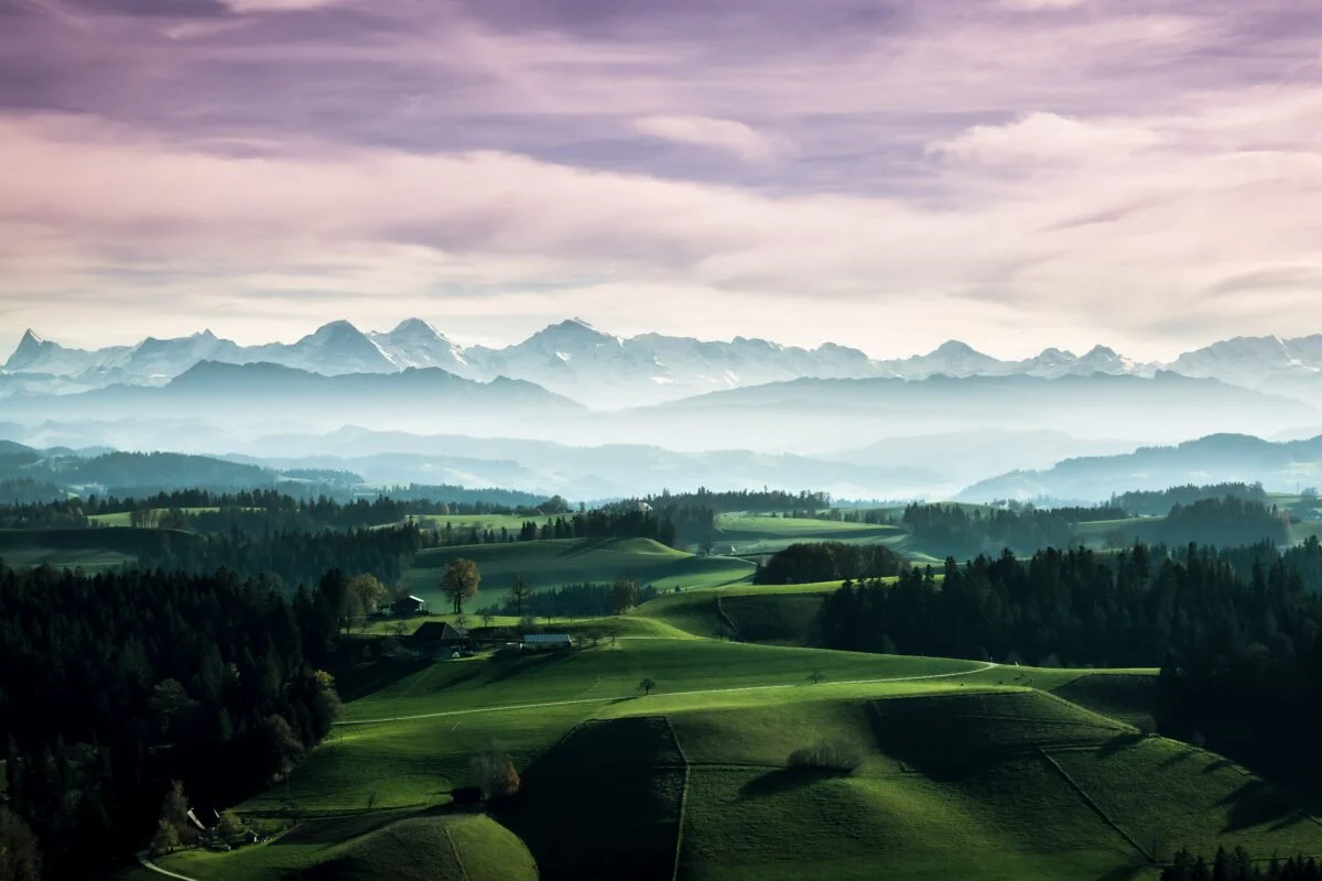 Aerial view of a golf course and mountains.