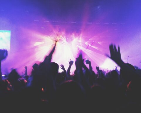 Analyzing qualitative data: crowd shot of a concert stage with purple lights
