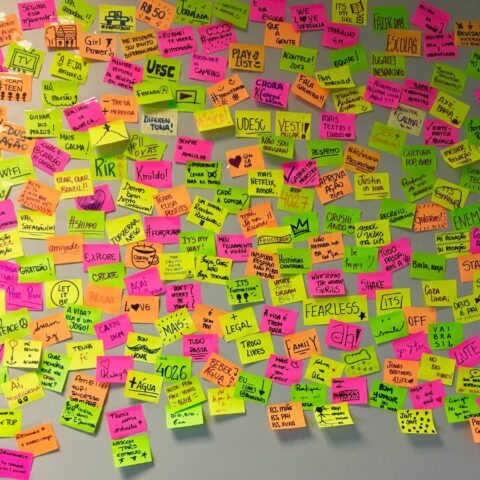 AI note-takers are replacing note set-ups like this whiteboard filled with unorganized sticky notes in bright colors.