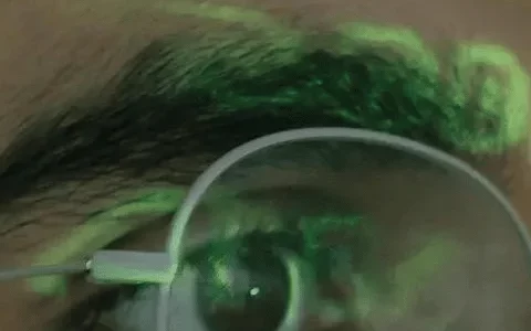 Close-up of a person with binary code reflected on their glasses.