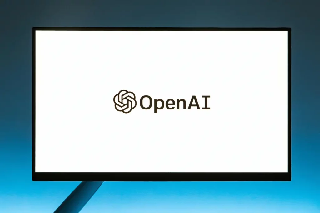 Computer monitor displaying the OpenAI logo on a white screen, emphasizing the company's focus on artificial intelligence technology.