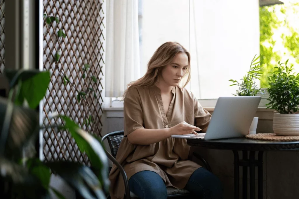 A person sitting at a table with a laptop.