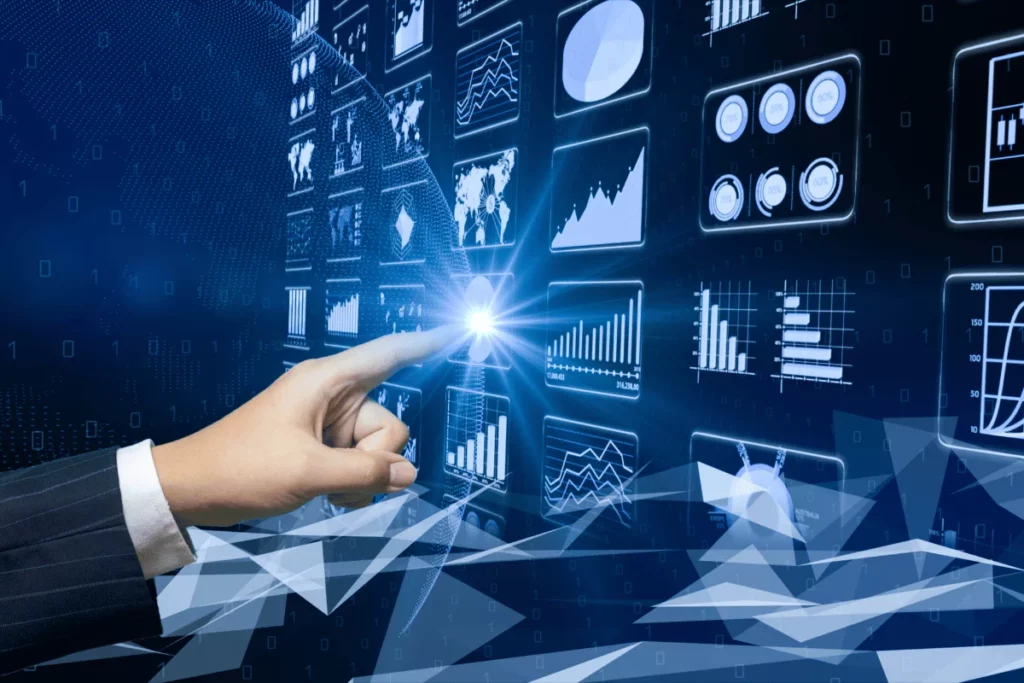 Hand pointing at data analytics charts on a digital screen.