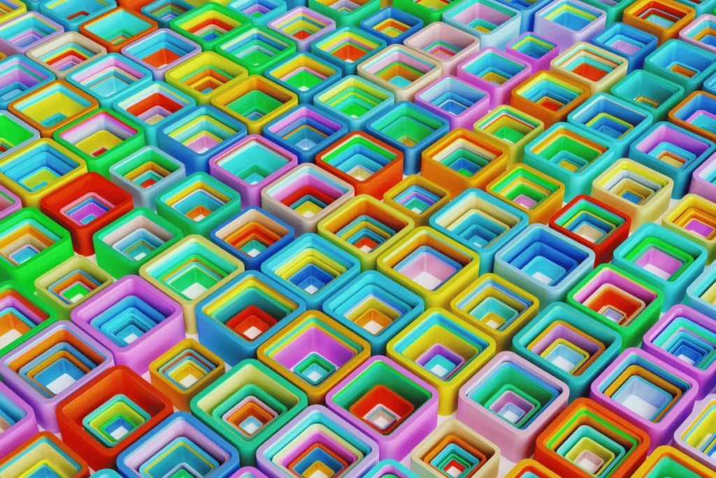 A close-up view of colorful, overlapping square shapes arranged in a grid, showcasing a spectrum of hues.