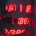 Red digital binary code projected over a person's face, symbolizing data encryption or virtual identity.