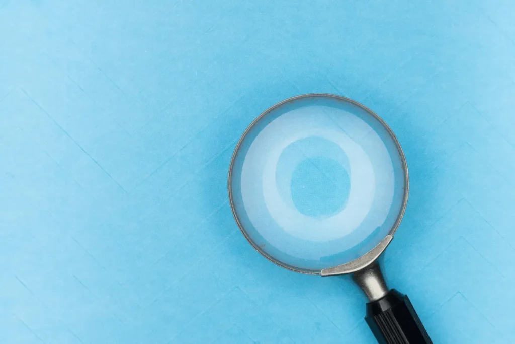 Magnifying glass on a blue textured background.