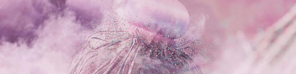 Abstract image featuring a translucent sphere surrounded by a cloud of pink and blue particles, creating a dreamy, ethereal atmosphere.