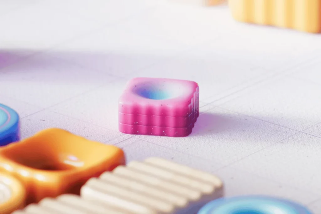 Close-up of a pink 3D object with a gradient center on a structured surface.