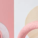 Abstract composition featuring pink and white geometric shapes against a light background, conveying a modern and artistic vibe.