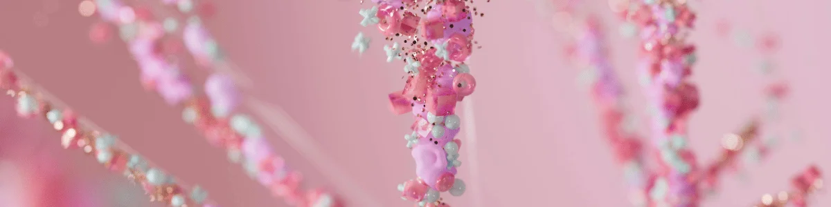 A close-up of colorful, whimsical decorations featuring pink and pastel beads shaped like cute animals, suspended against a soft pink background.