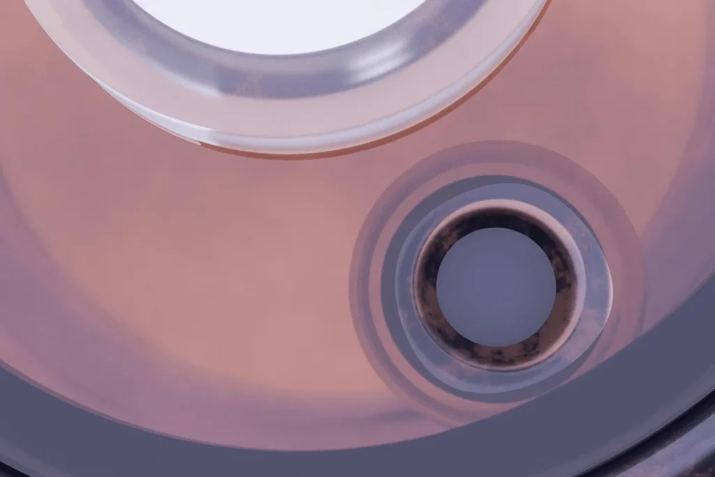 Abstract image showing concentric circular elements with a slight gradient from pink to brown.