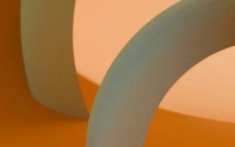 Abstract 3D rendering of smooth, curved shapes in cream and orange tones.
