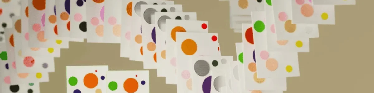 Colorful pattern of paper cards with varying circles in different hues like orange, green, and purple.