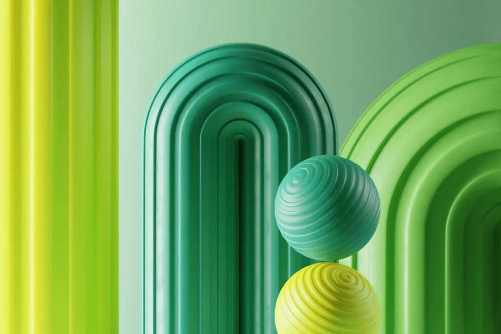 Vibrant green and yellow 3D geometric shapes with smooth textures and rounded designs.