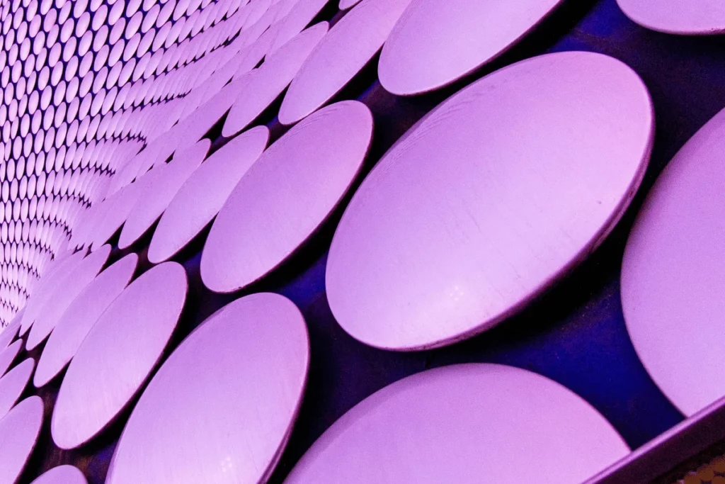 Close-up of a geometric pattern of purple circular panels arranged in a repeating pattern.