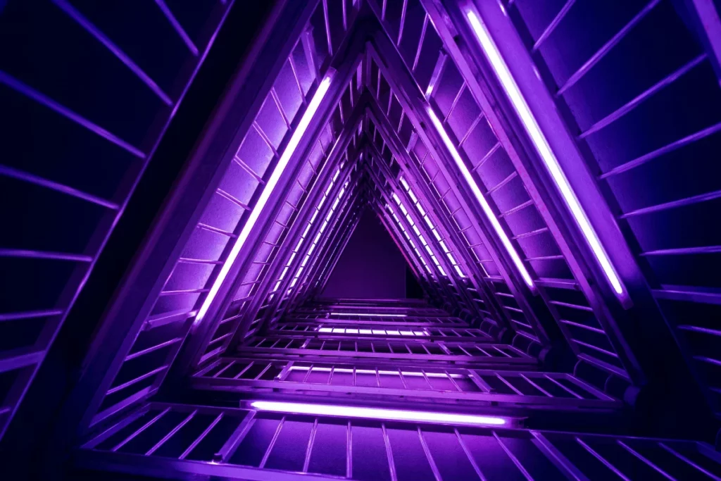 Abstract purple triangular light pattern with neon strips creating depth.