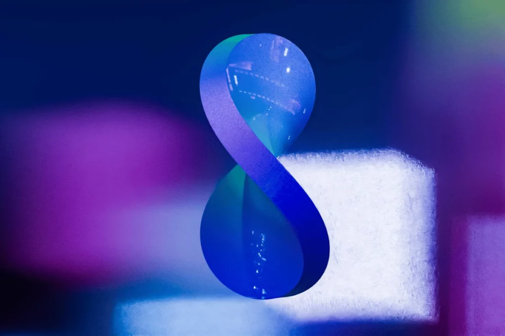 A futuristic design featuring a smooth, twisting number 8 shape with vibrant blue and purple lighting.