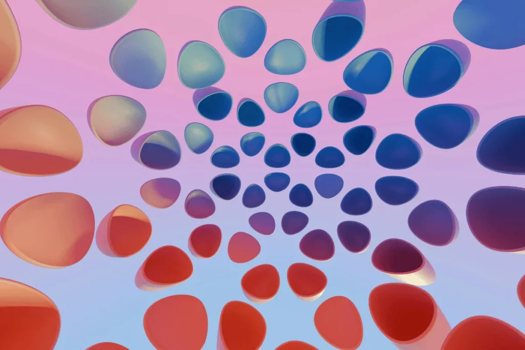Abstract 3D illustration of floating red and blue ovals arranged in a spiral pattern against a soft pink background.