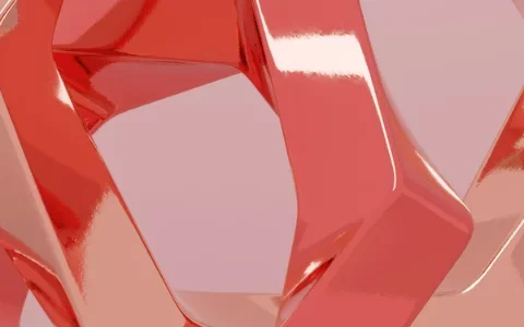 A glossy, intertwined sculpture with smooth, coral-colored surfaces against a soft pink background.