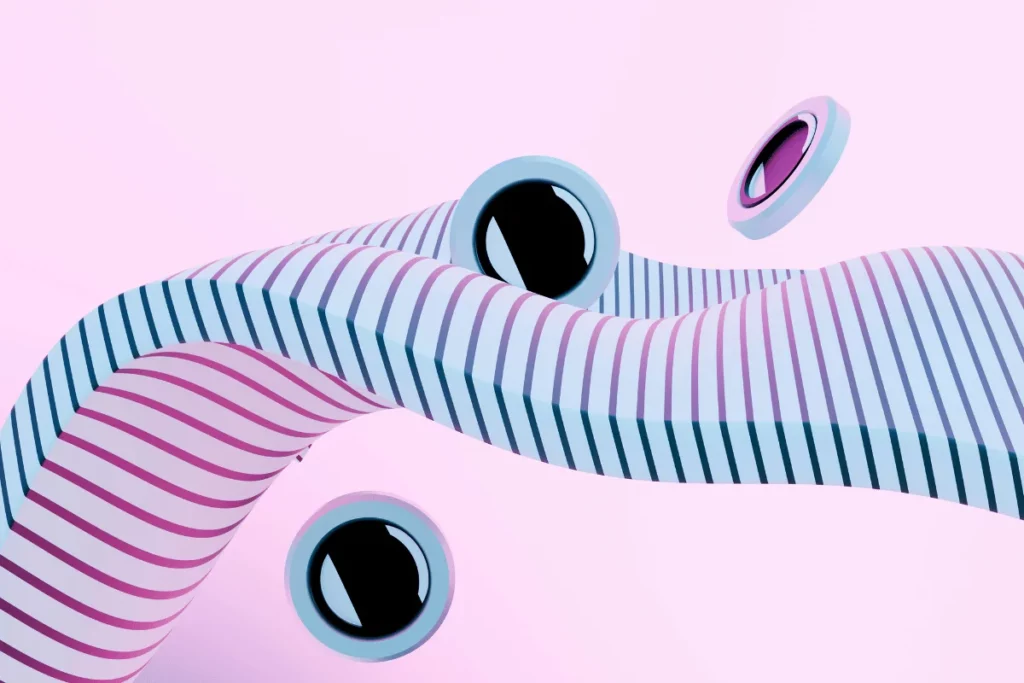 Abstract composition of wavy striped shapes in pink and blue, featuring floating circular elements with glossy black and purple surfaces.