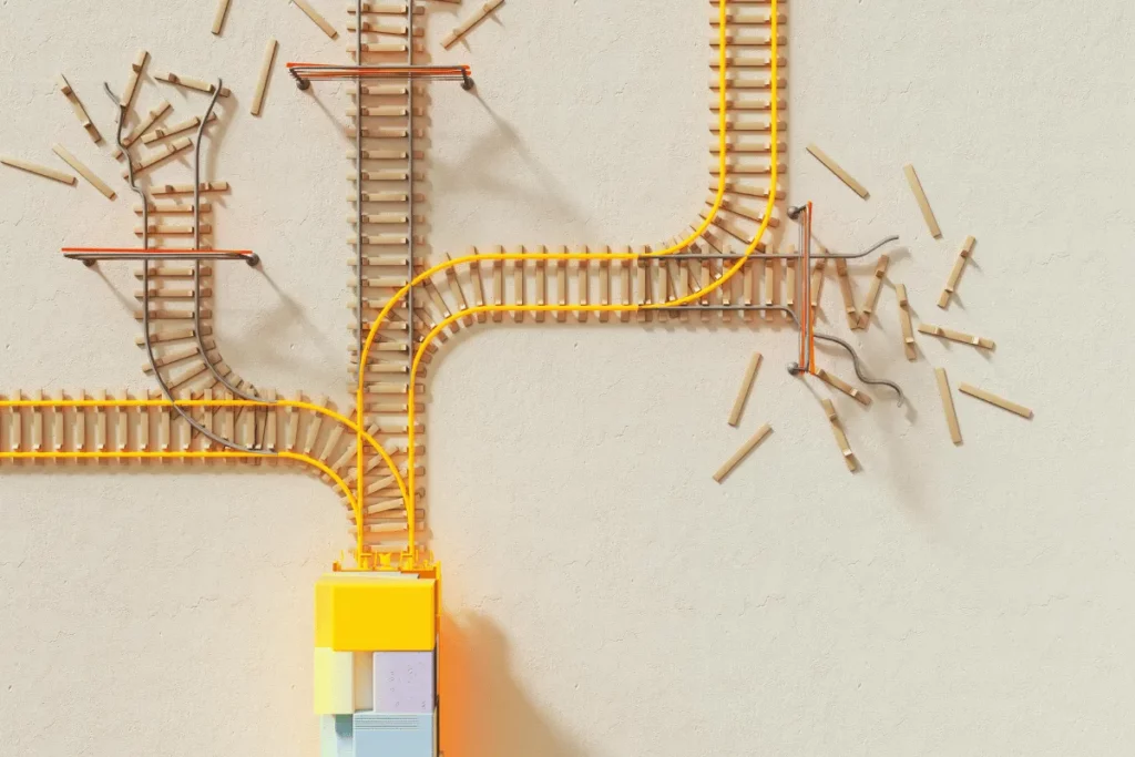 Model train tracks with forks and broken segments, depicting divergence and disruption.
