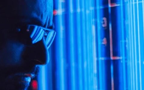 A glowing blue digital display with vertical lines and abstract shapes, showcasing a high-tech environment or interface.