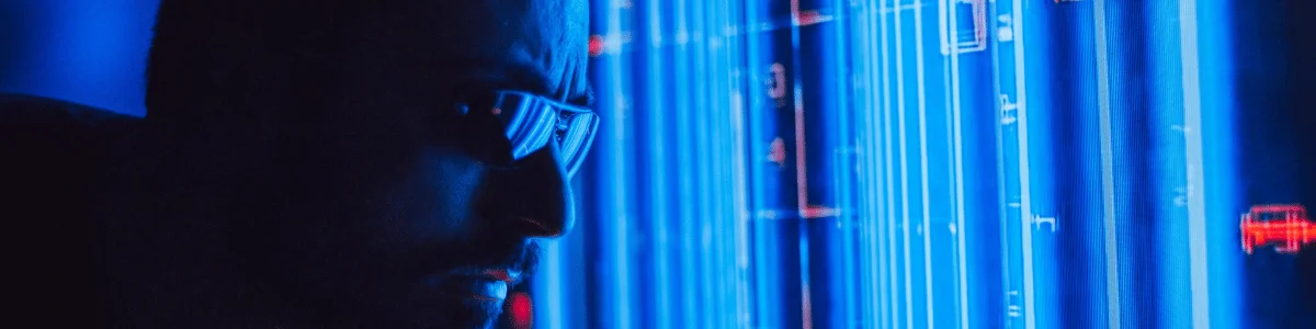 A glowing blue digital display with vertical lines and abstract shapes, showcasing a high-tech environment or interface.