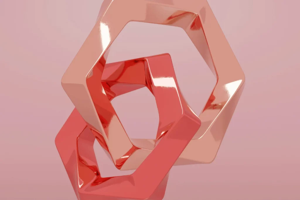 Abstract geometric shapes in shades of pink and red, reflecting light
