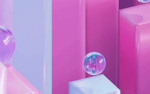 Colorful 3D composition of pink and blue blocks with glass-like bubbles suspended in the air.