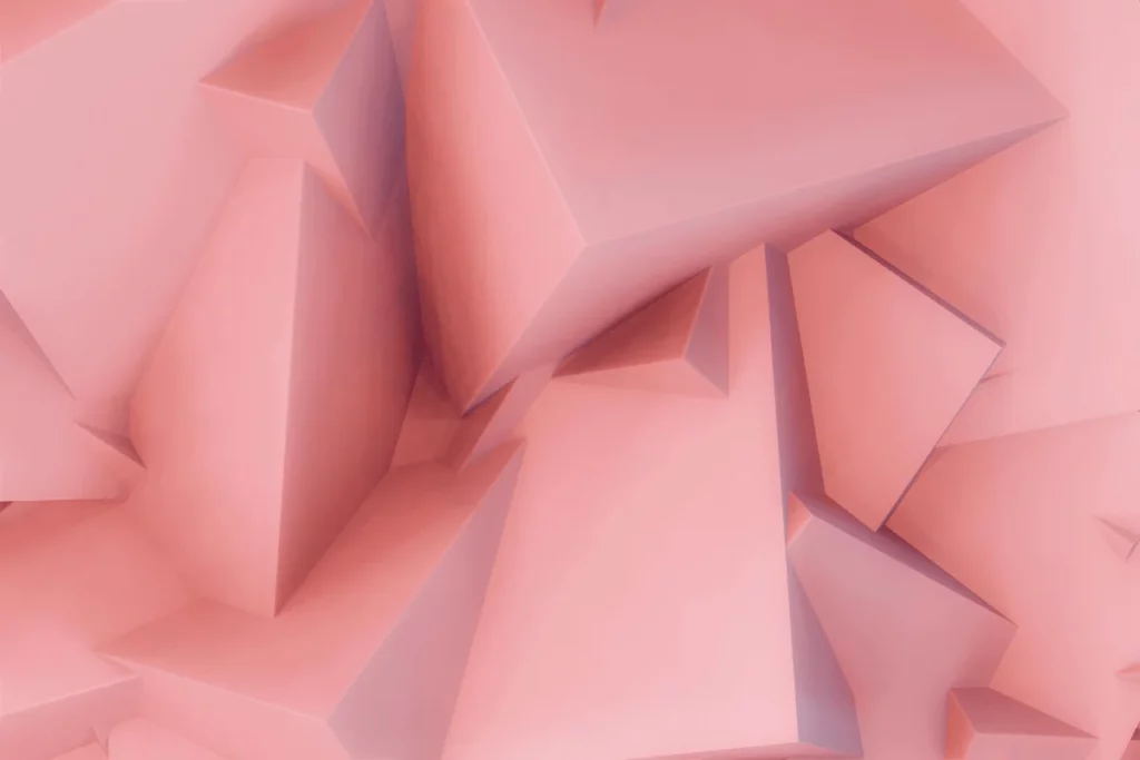 Close-up of 3D pink geometric shapes with sharp angles and intricate textures.