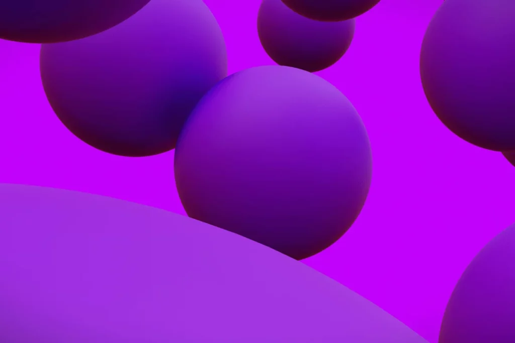 Abstract purple spheres floating in a vibrant purple background.