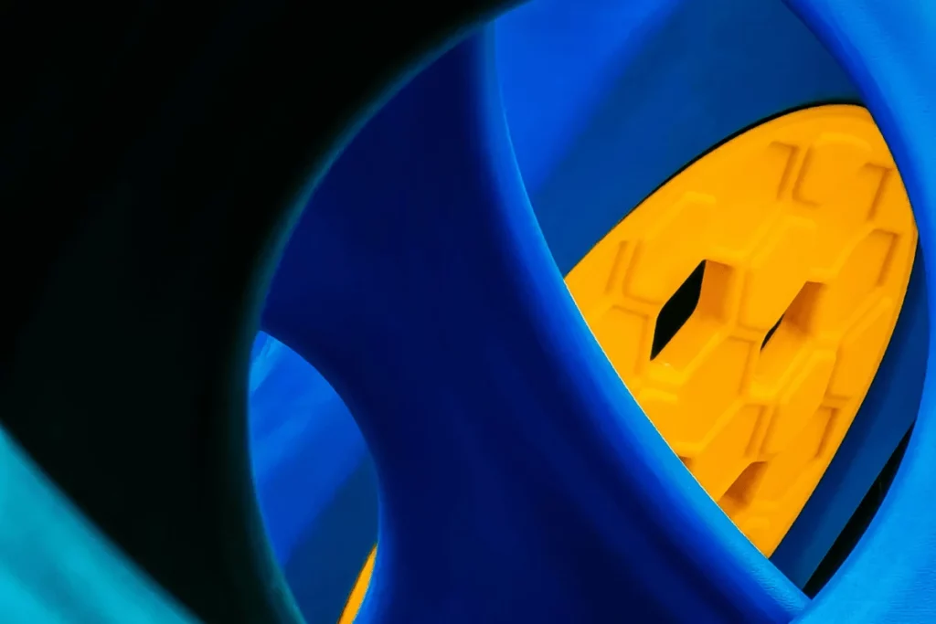 Close-up of blue and yellow geometric shapes with a honeycomb pattern in the center.