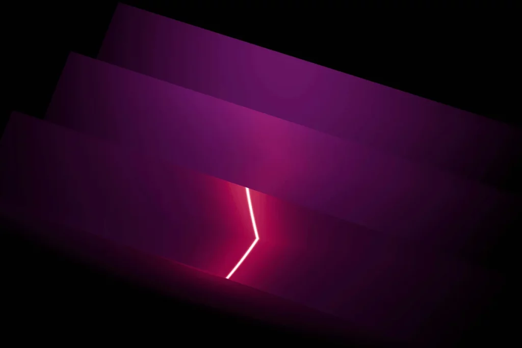 Abstract geometric design featuring layers of purple gradients with a glowing white line cutting through the center.