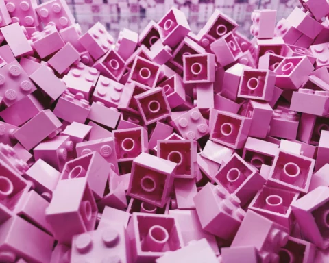 A pile of pink legos representing the vast amount of market research insights you can store in your research repository