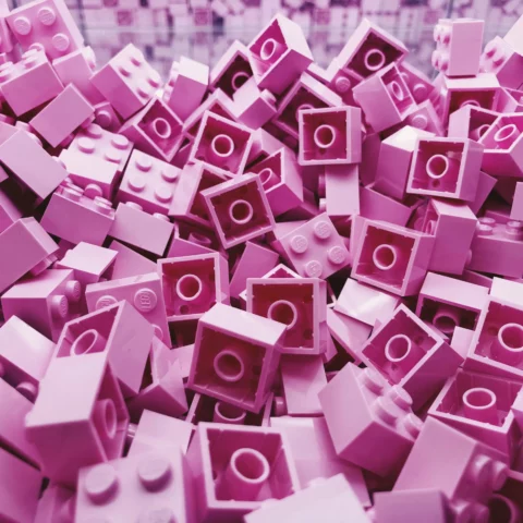 A pile of pink legos representing the vast amount of market research insights you can store in your research repository
