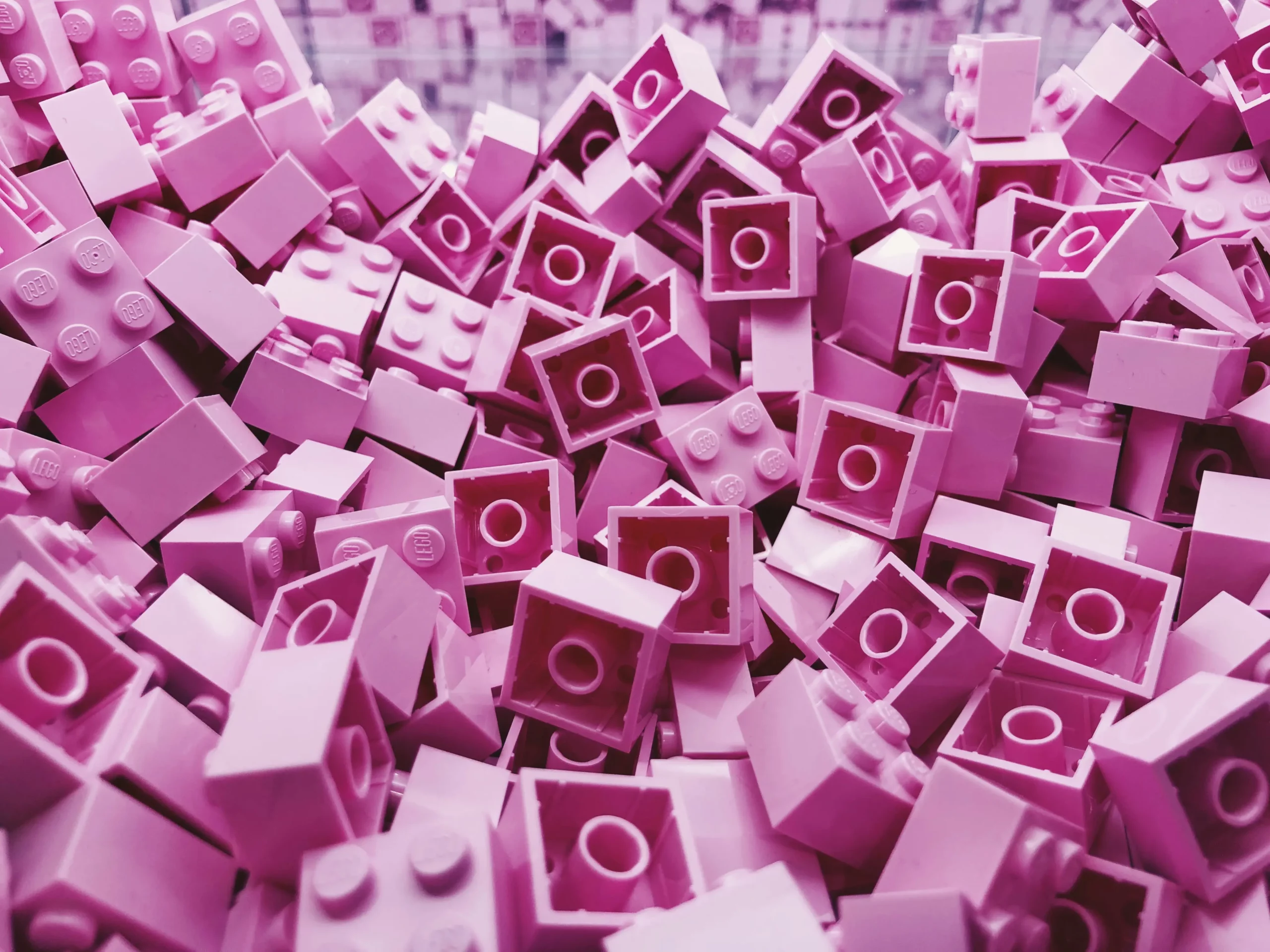 A pile of pink legos representing the vast amount of market research insights you can store in your research repository