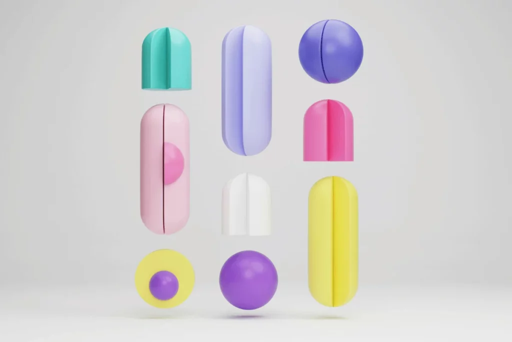 Vibrant and playful composition of 3D geometric shapes like spheres, cones, and capsules in pastel colors against a neutral background.