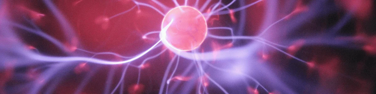 Close-up of an energy sphere surrounded by glowing electric filaments in purple and red hues. Abstract representation of electrical activity.