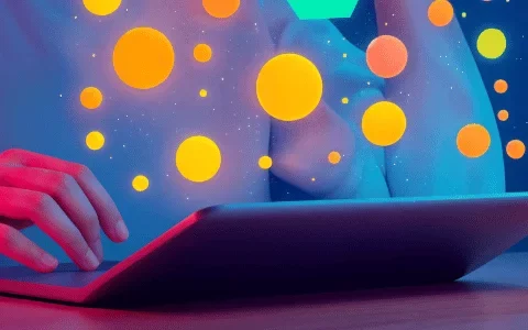 A person using a tablet with colorful, glowing orbs floating around them, illuminated by vibrant blue and pink lighting.