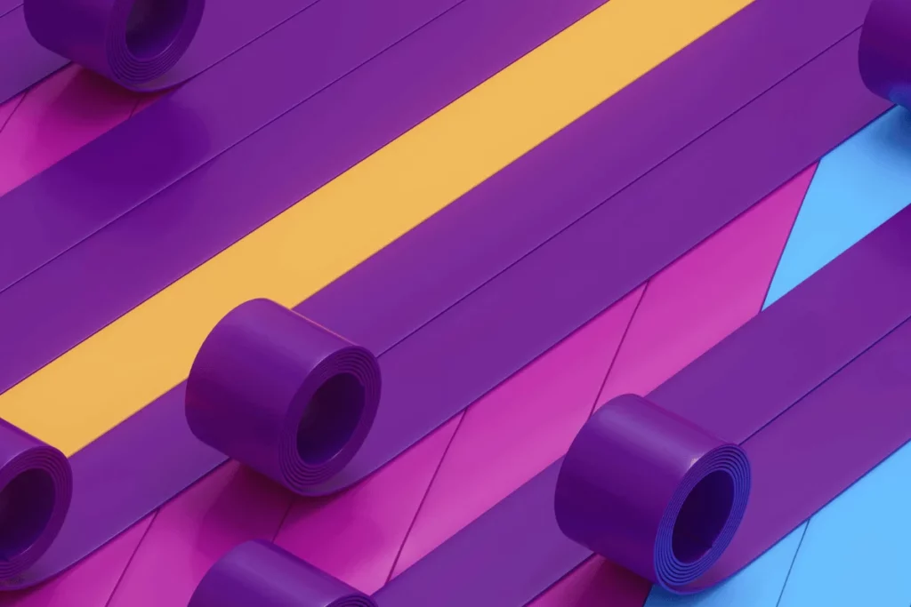 Rolls of vibrant purple ribbon arranged diagonally on colorful background.