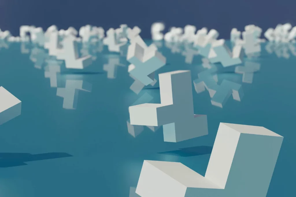 Abstract 3D cross-shaped blocks floating on reflective water.